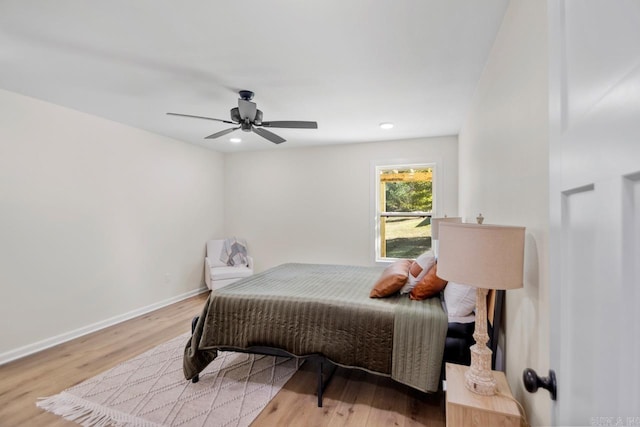 bedroom with ceiling fan and light hardwood / wood-style flooring