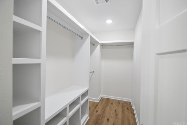 spacious closet featuring hardwood / wood-style floors