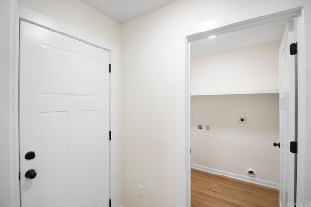 clothes washing area featuring hookup for a washing machine, light hardwood / wood-style floors, and electric dryer hookup