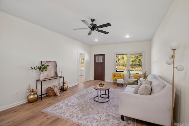 living room with ceiling fan and wood-type flooring