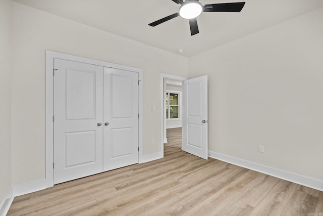 unfurnished bedroom with a closet, light hardwood / wood-style floors, and ceiling fan