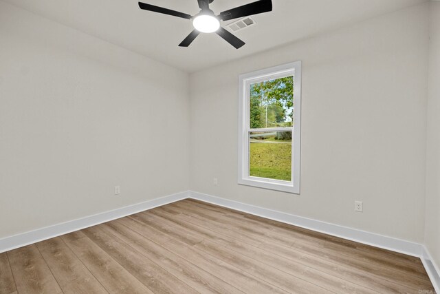 unfurnished room with light wood-type flooring and ceiling fan