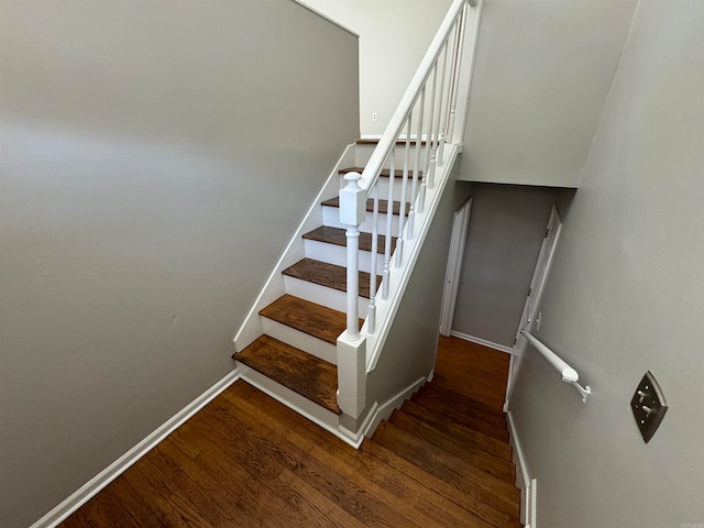 stairs featuring hardwood / wood-style flooring