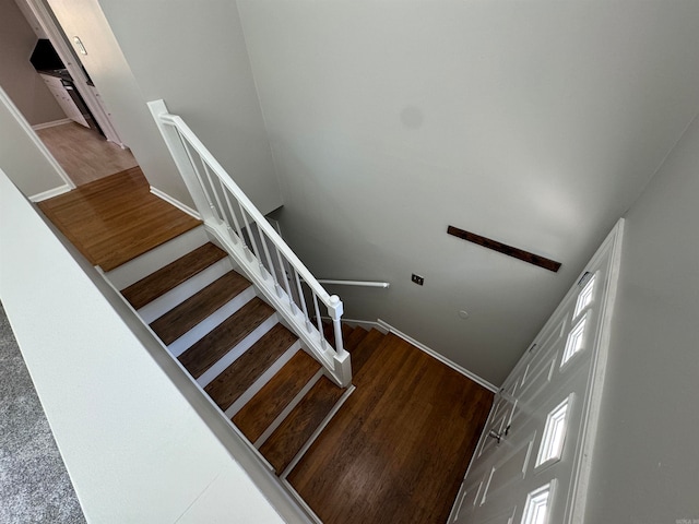 stairs with hardwood / wood-style floors