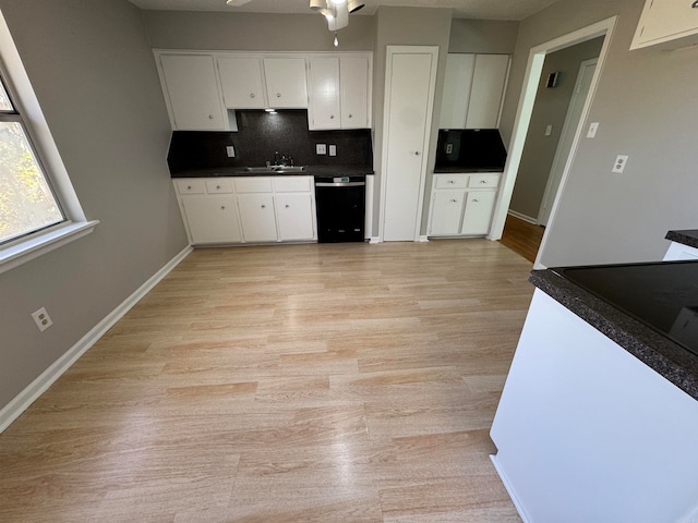 kitchen with white cabinetry, sink, ceiling fan, tasteful backsplash, and light wood-type flooring