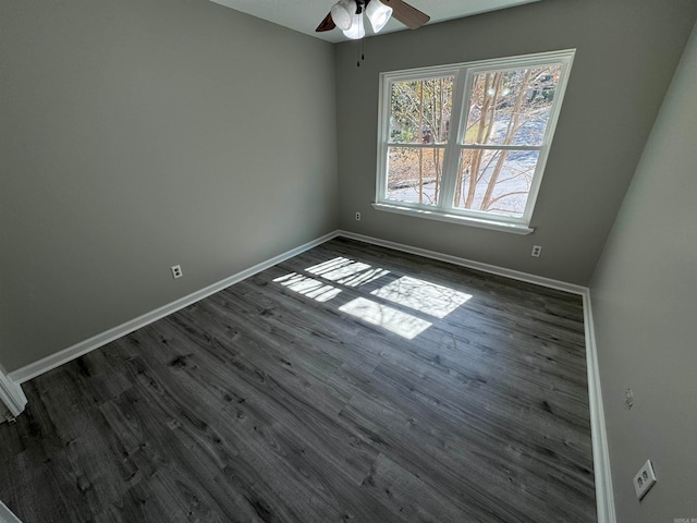 empty room with ceiling fan and dark hardwood / wood-style flooring