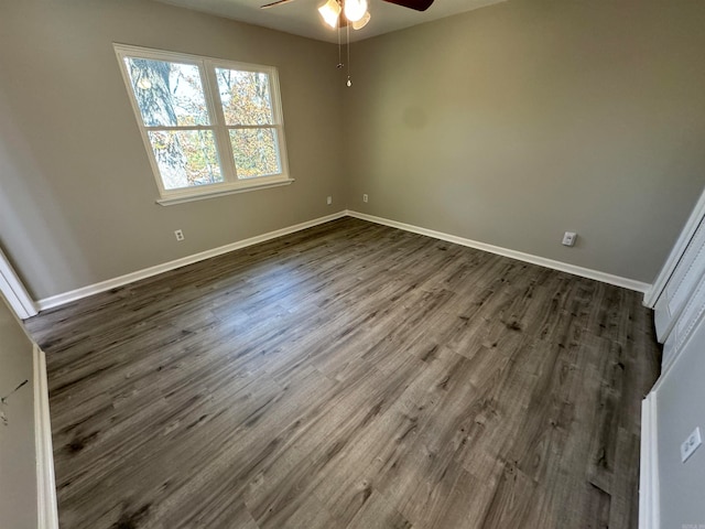 empty room with ceiling fan and dark wood-type flooring