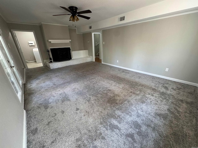 unfurnished living room with carpet flooring, ornamental molding, ceiling fan, and a fireplace