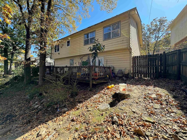 rear view of house with a wooden deck