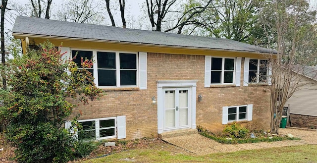 bi-level home with a front lawn