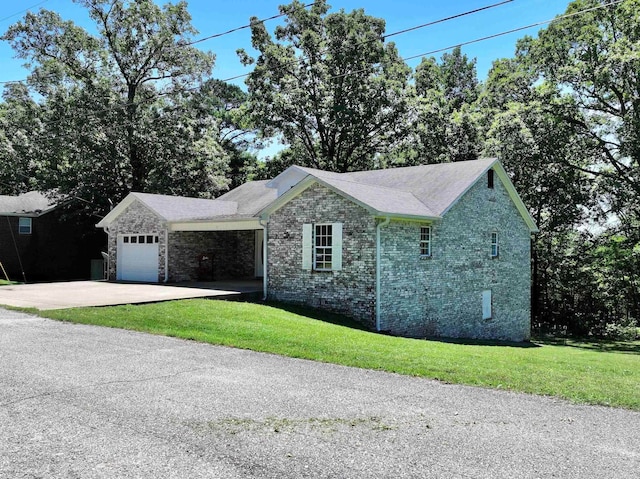 ranch-style house with a garage and a front lawn