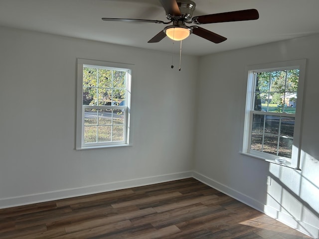 spare room featuring ceiling fan and dark wood-type flooring