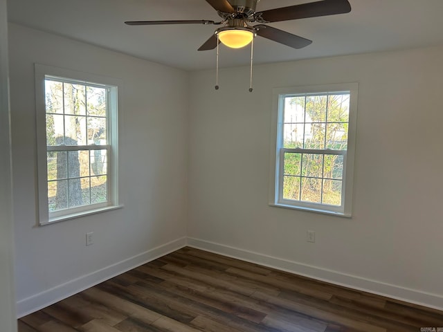 spare room with ceiling fan and dark wood-type flooring