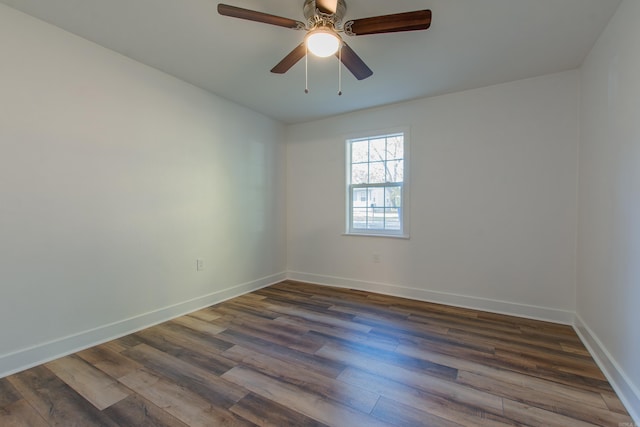 spare room with ceiling fan and dark wood-type flooring