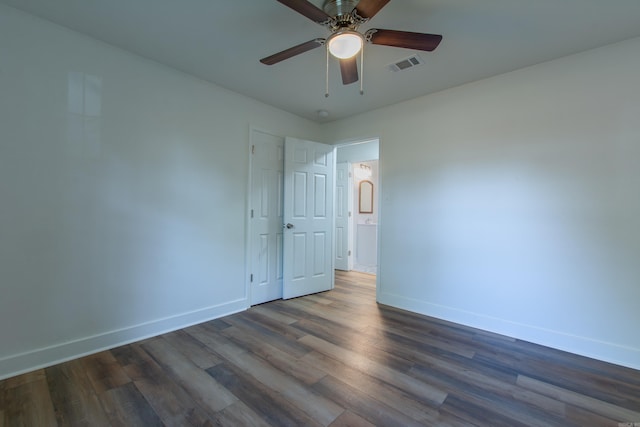 unfurnished room featuring ceiling fan and dark hardwood / wood-style flooring