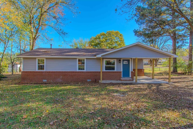 ranch-style house with a front yard and a carport