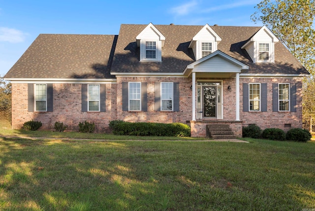 cape cod home with a front lawn