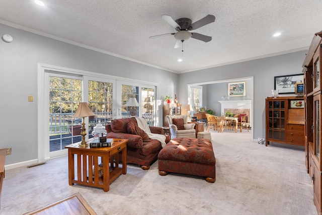 carpeted living room featuring ceiling fan, crown molding, and a textured ceiling