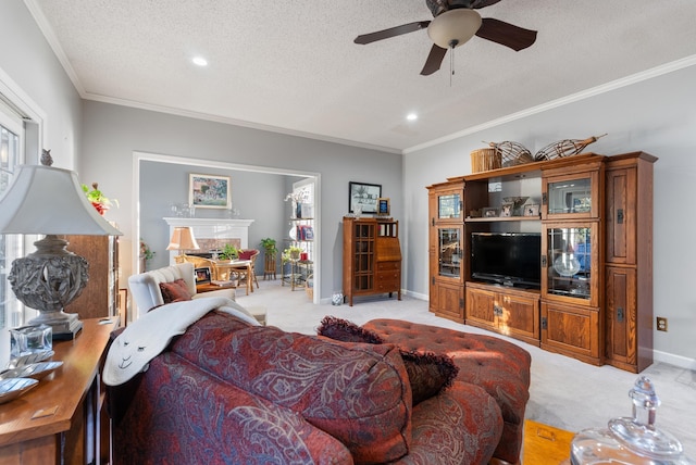 living room with light carpet, ceiling fan, a textured ceiling, and ornamental molding