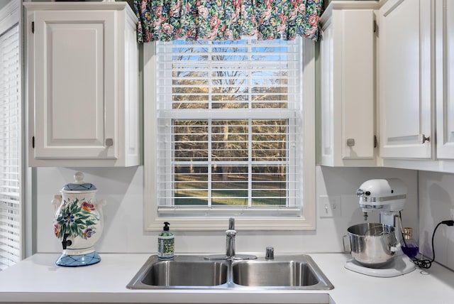 kitchen featuring sink and white cabinets