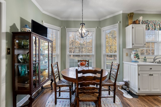 dining room featuring a chandelier, crown molding, dark wood-type flooring, and a textured ceiling