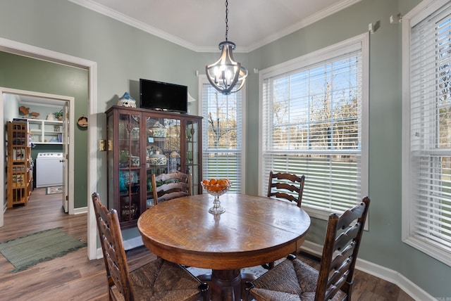 dining room featuring a chandelier, wood-type flooring, and crown molding