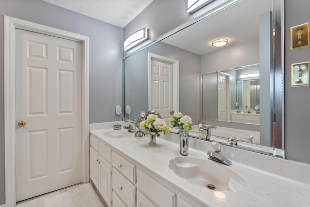 bathroom featuring vanity and a textured ceiling