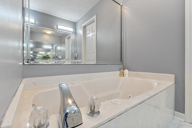 bathroom featuring a bath and a textured ceiling