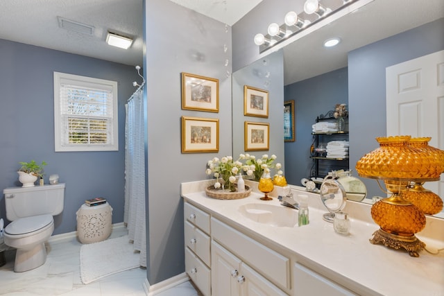 bathroom with curtained shower, vanity, a textured ceiling, and toilet