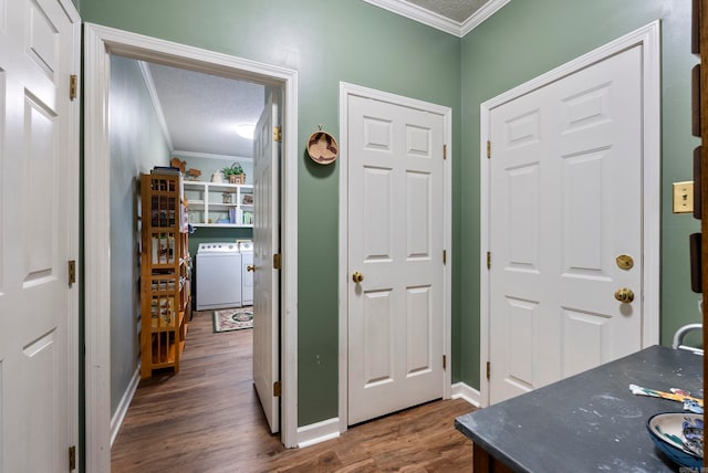 interior space with a textured ceiling, crown molding, washer and dryer, and dark hardwood / wood-style floors