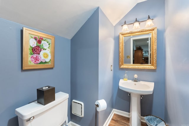 bathroom featuring hardwood / wood-style floors, toilet, and lofted ceiling