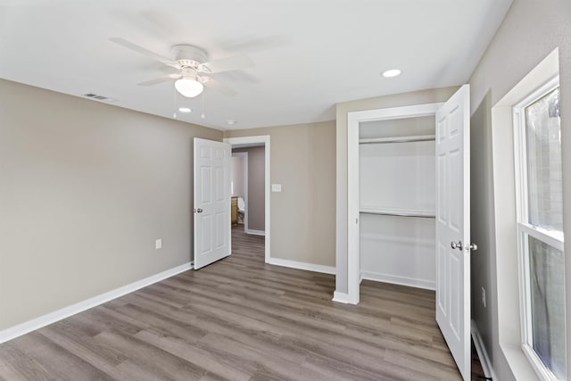 unfurnished bedroom with a closet, ceiling fan, and light hardwood / wood-style flooring