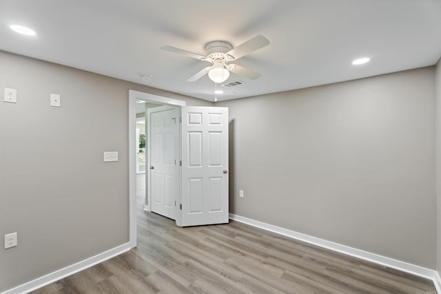 empty room with light hardwood / wood-style floors and ceiling fan