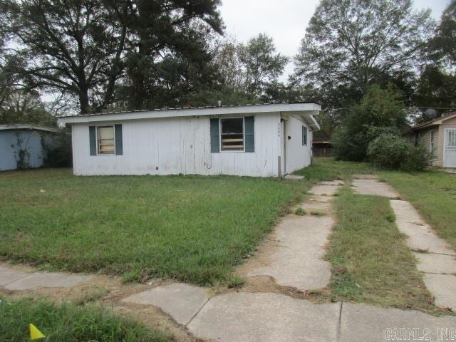 view of property exterior with a lawn