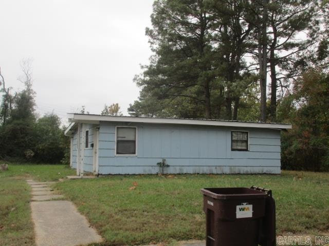 view of side of home featuring a lawn