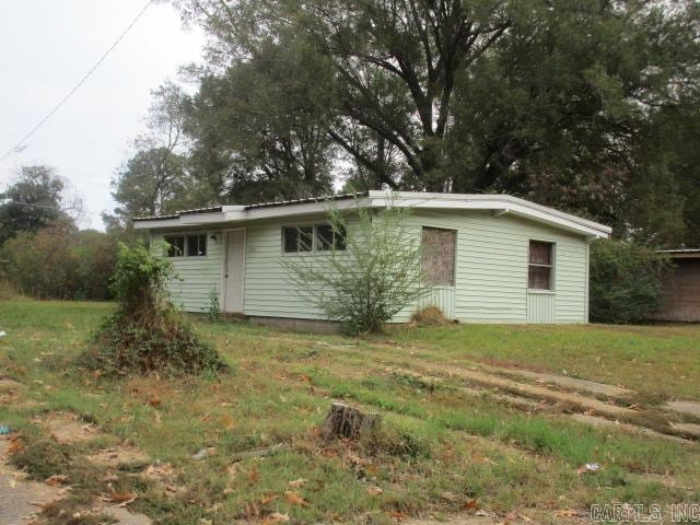 rear view of property featuring a yard