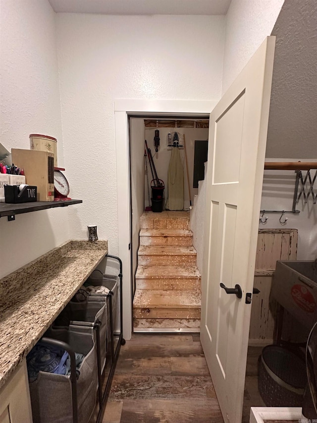 staircase featuring wood-type flooring