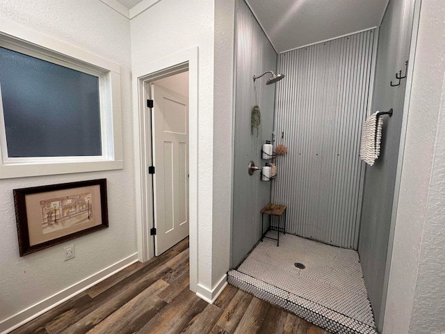 bathroom featuring hardwood / wood-style floors and walk in shower