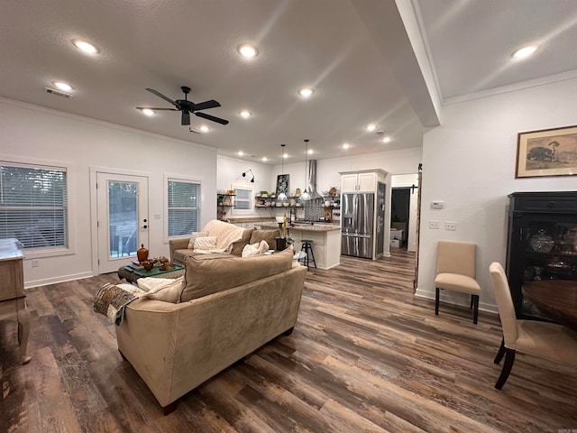 living room with ceiling fan, dark hardwood / wood-style floors, and ornamental molding