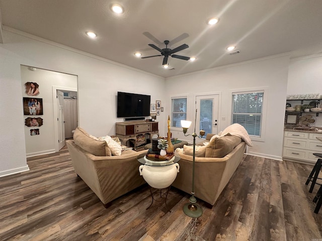 living room with ceiling fan, crown molding, and dark hardwood / wood-style floors