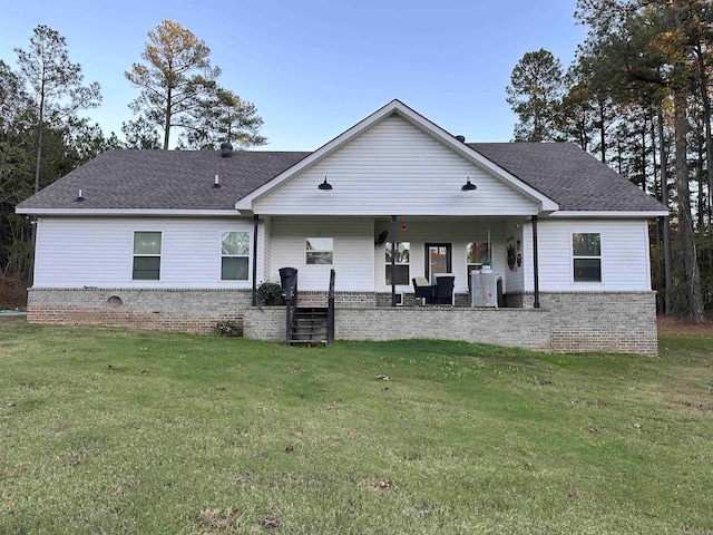 back of property featuring a lawn