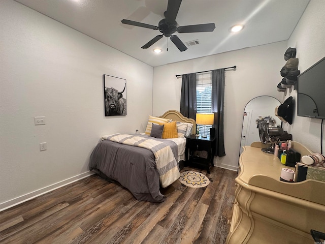 bedroom with ceiling fan and dark hardwood / wood-style floors