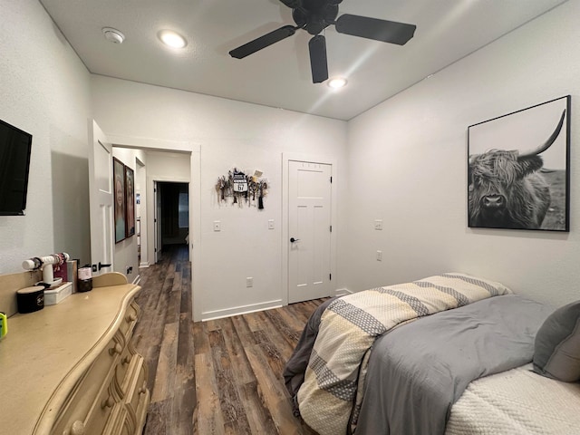 bedroom with dark hardwood / wood-style floors and ceiling fan