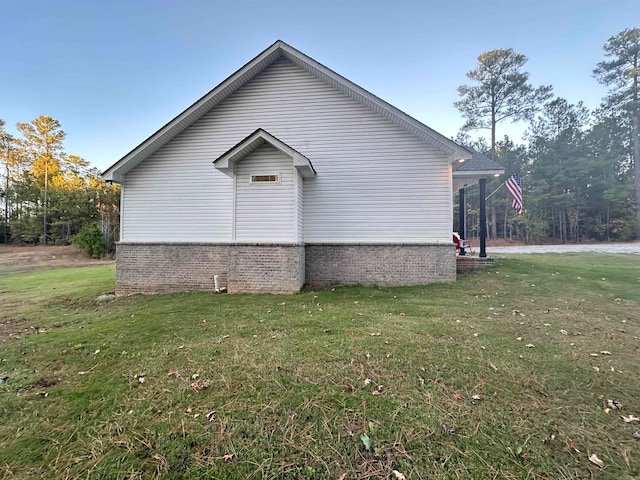 view of property exterior with a yard