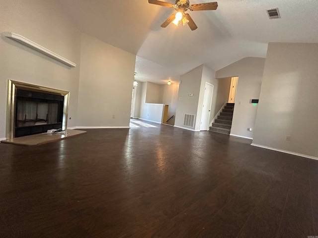 unfurnished living room featuring ceiling fan, dark hardwood / wood-style flooring, and vaulted ceiling