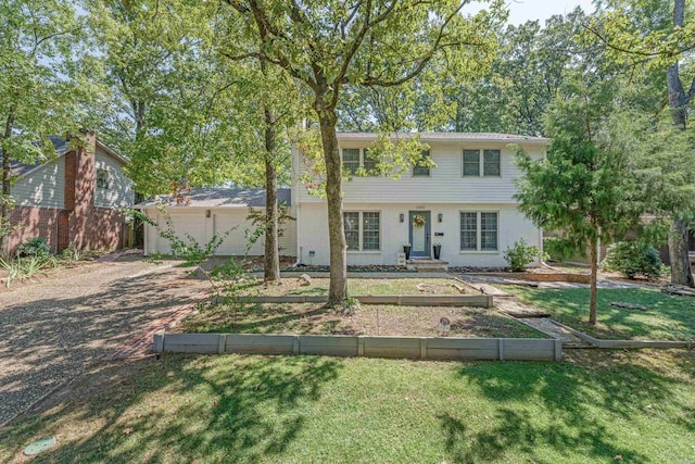 view of front facade with a front lawn and a garage