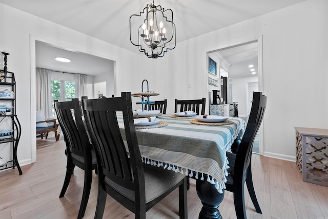 dining space featuring a chandelier and light wood-type flooring