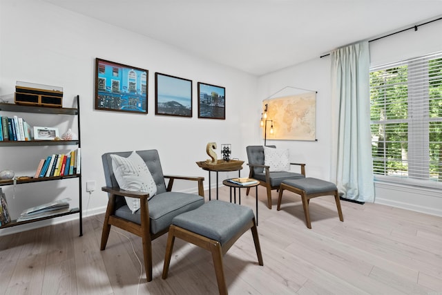 sitting room featuring plenty of natural light and light hardwood / wood-style flooring