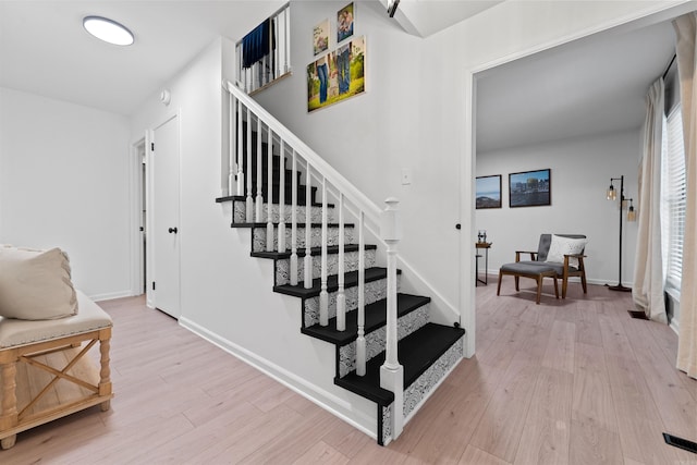 stairway with hardwood / wood-style floors