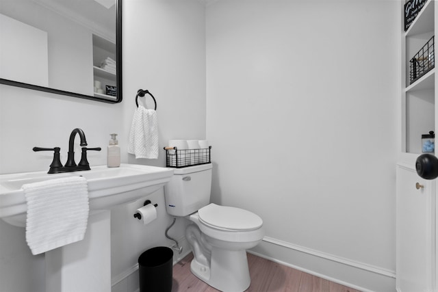 bathroom with hardwood / wood-style flooring and toilet